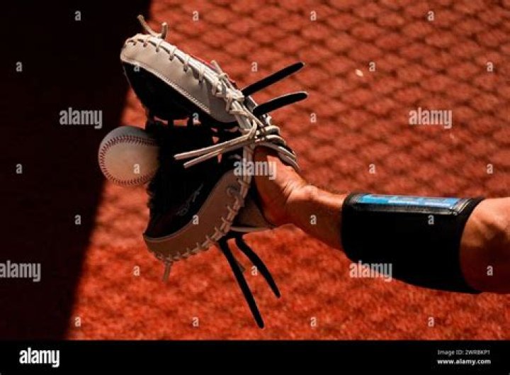 Can a bullpen catcher play in a game?