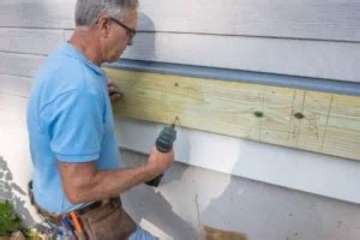 Can you put a ledger board over siding?