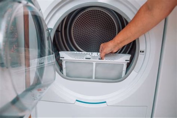 How do I clean the lint from my Maytag front load dryer?
