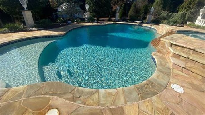 How do you clean a pebble pool deck?