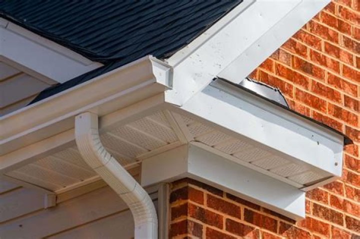 How far should rain gutters extend from house?