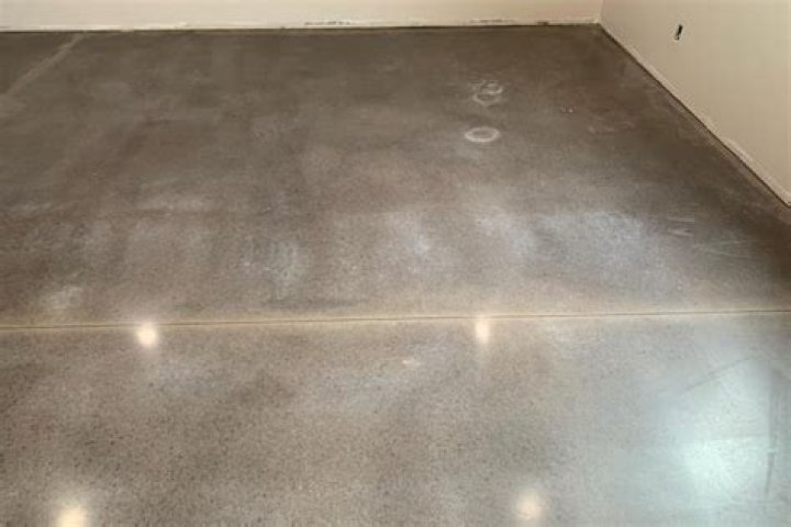 What causes white stains on concrete?