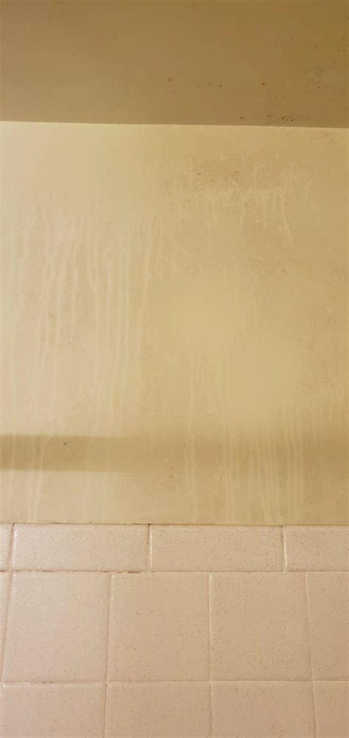 What causes yellow drips on bathroom walls?