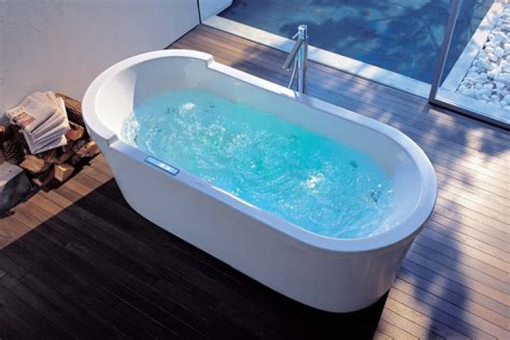 What is the difference between a whirlpool tub and an air bath?