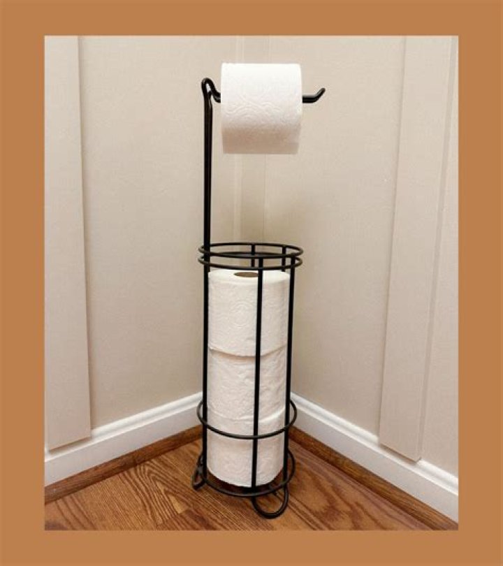 Where should a toilet paper holder be placed?