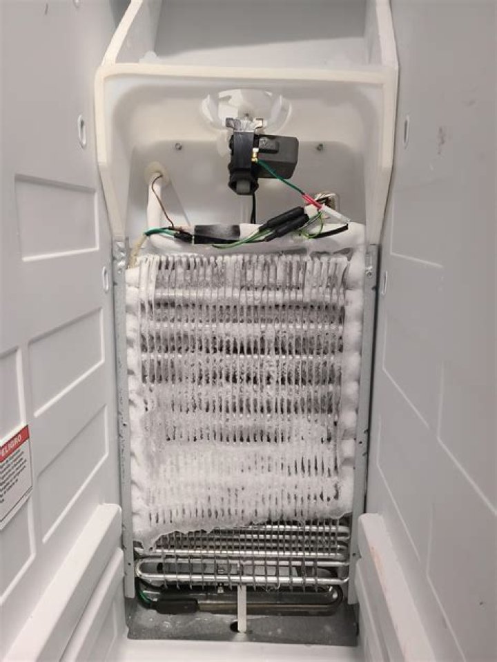 Why do refrigerator evaporator coils freeze?